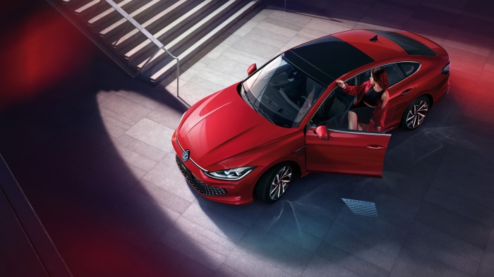 Red Volkswagen Lamando L with woman
