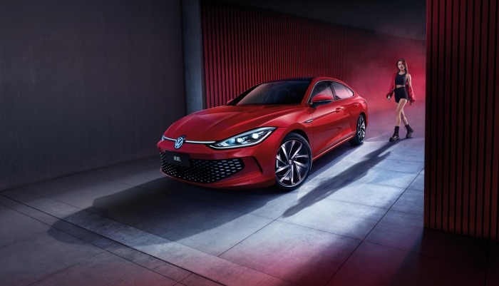 Red Volkswagen Lamando L with woman