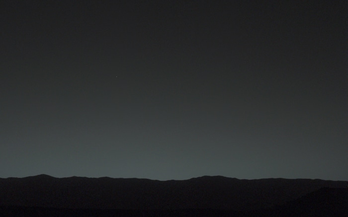 Mars landscape with a distant star at night