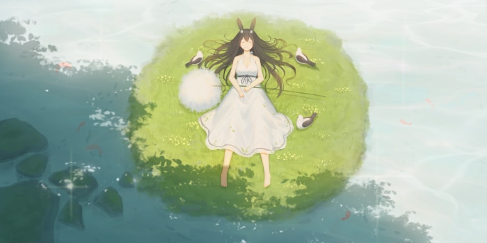 Girl lying on grass with birds