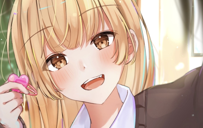 Girl with blonde hair holding a heart clip