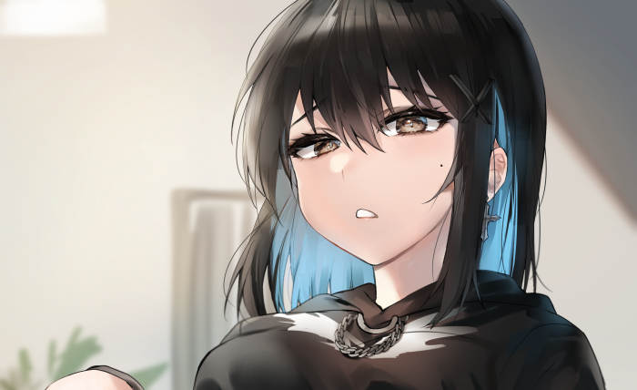 Girl with black and blue hair wearing a hoodie