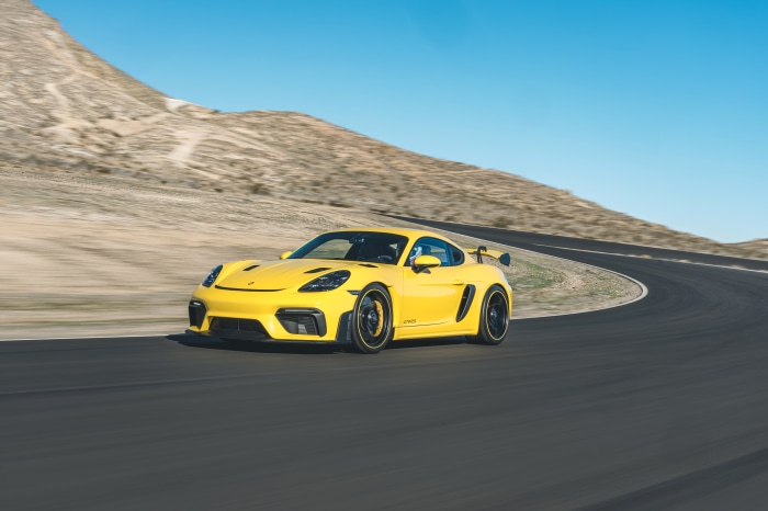Yellow Porsche 718 Cayman GT4 on a Racetrack