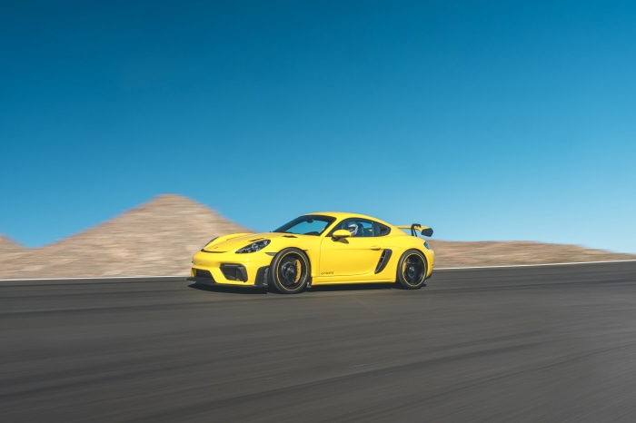 Yellow Porsche 718 Cayman GT4 on a race track