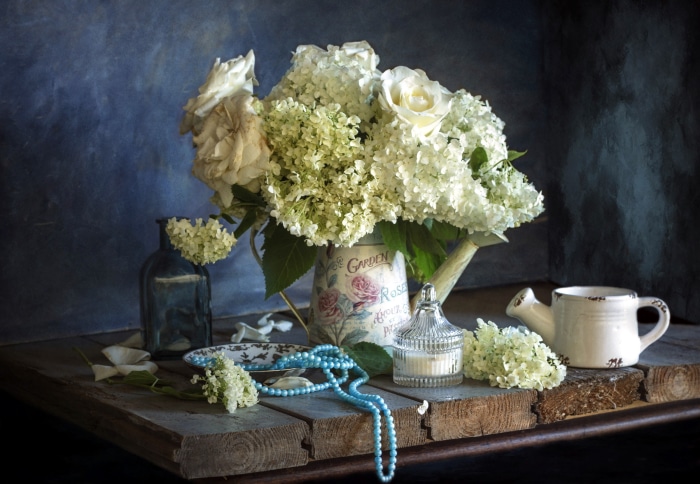 Still life with flowers and watering can