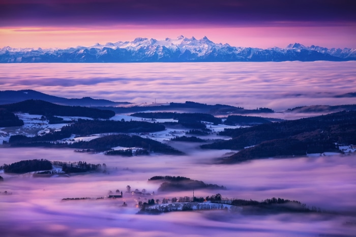 Mountain range above sea of clouds at sunrise