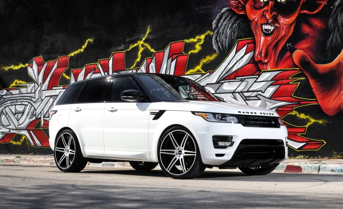 White Range Rover Sport in front of graffiti wall