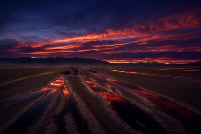Desert landscape with colorful sunset and water channels