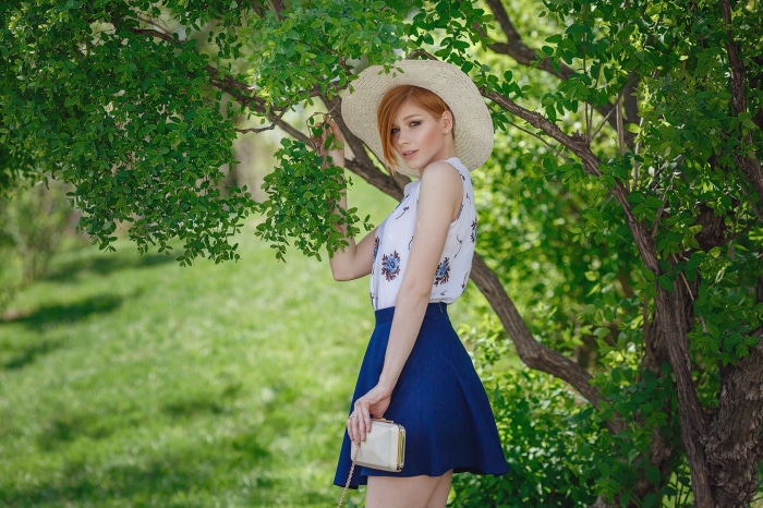 Anastasia Zhilina in a straw hat and blue skirt