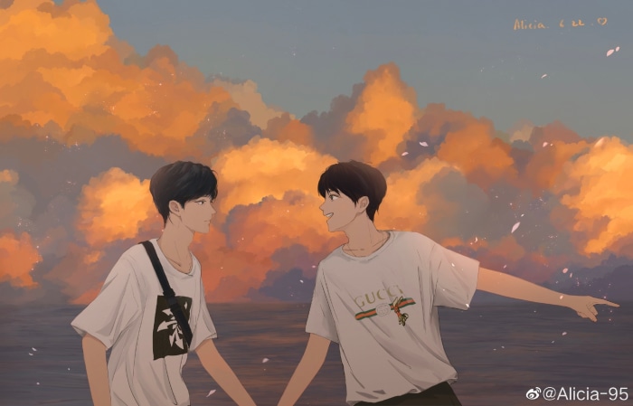 Two young men by the sea at sunset