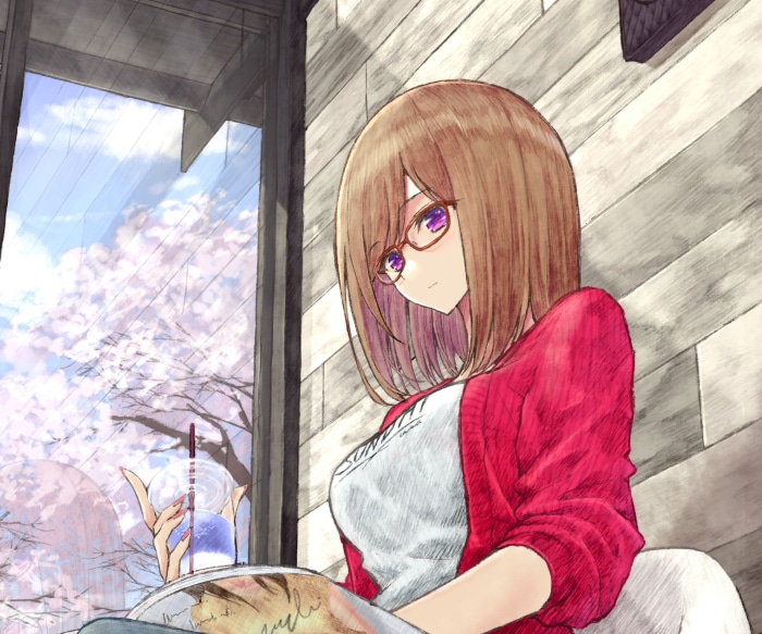 Girl with glasses reading a book and drinking a beverage