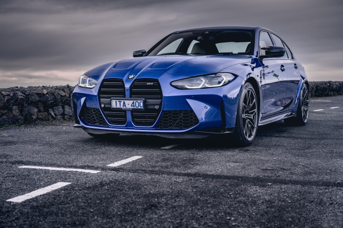 Blue BMW M3 Sedan on Paved Road