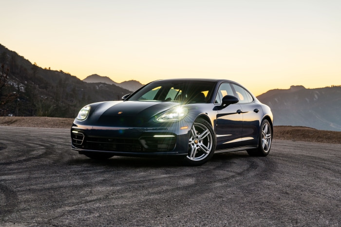 Dark Blue Porsche Panamera on a Mountain Road at Sunset