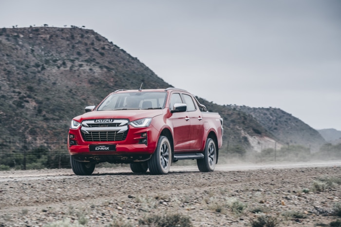 Red Isuzu D-Max 4x4 Double Cab driving on dirt road