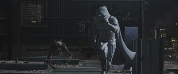 Moon Knight running from a creature on a rooftop