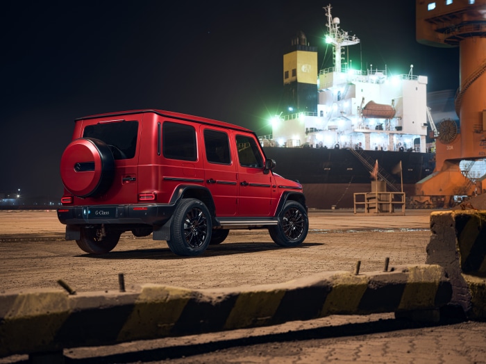 Red Mercedes-Benz G-Class parked at a port at night