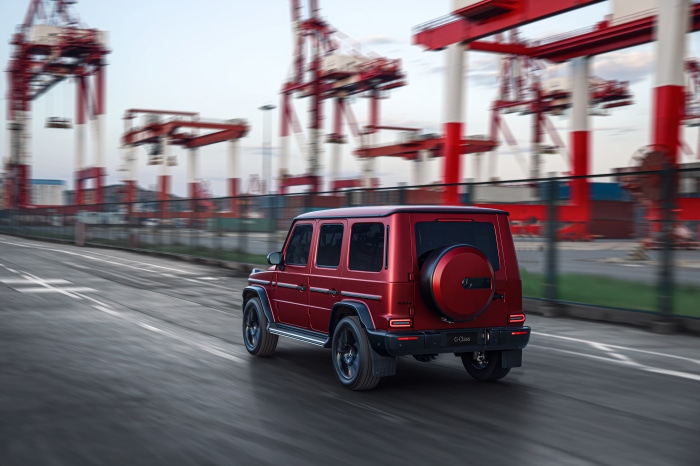 Red Mercedes-Benz G-Class driving in port