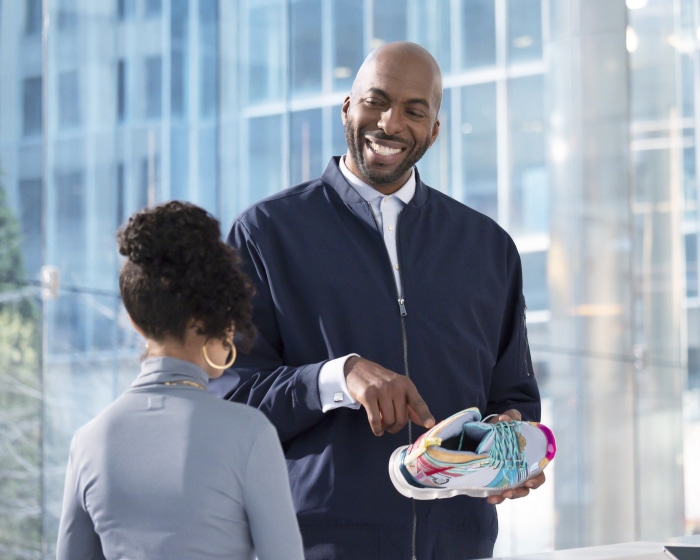 John Salley holding a sneaker
