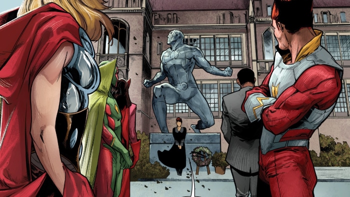 Avengers at a memorial with Vision statue
