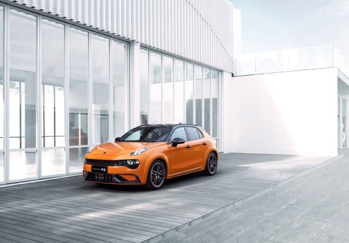 Orange Lynk & Co 02 Hatchback parked on wooden deck
