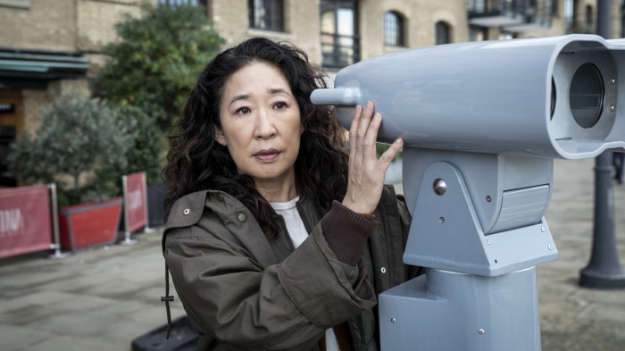 Sandra Oh from Killing Eve looking through a telescope