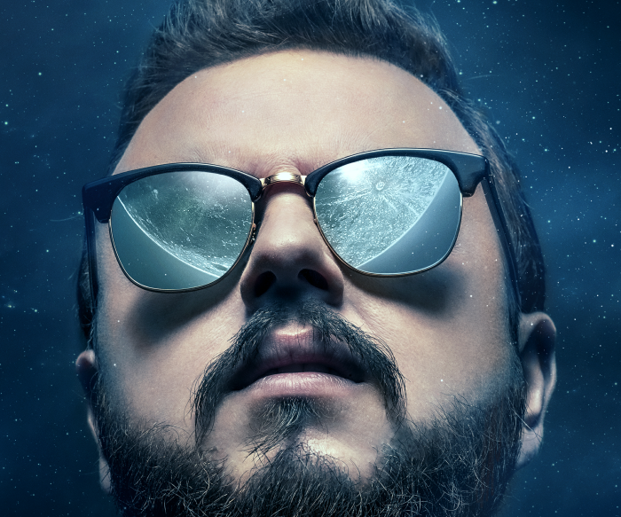 John Bradley wearing sunglasses reflecting the moon