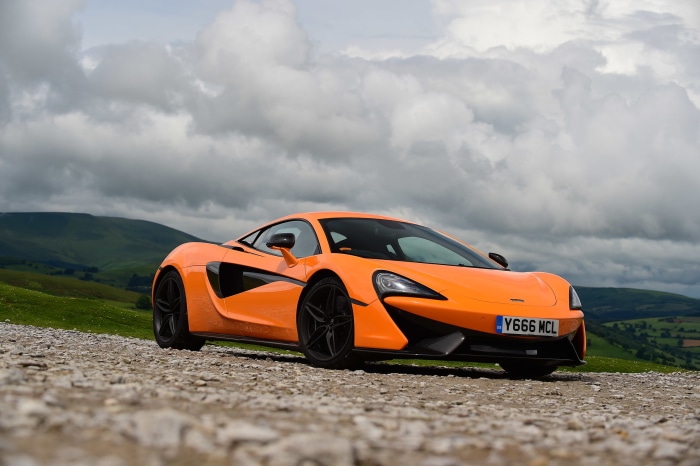 Orange McLaren 570S car on a gravel road