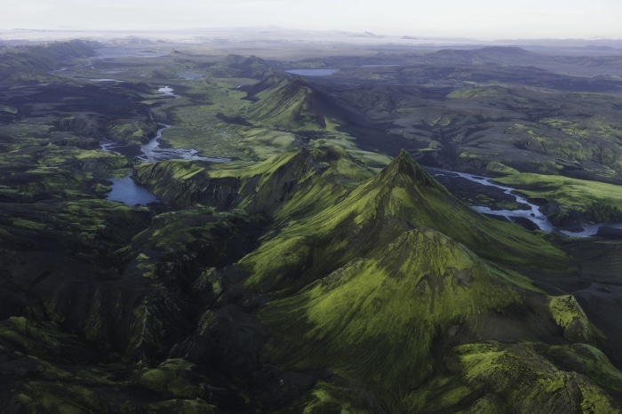 Aerial view of a green mountainous landscape in Iceland