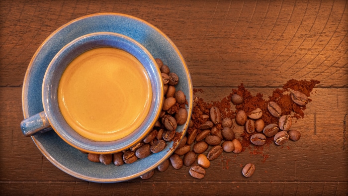 Coffee cup with beans and grounds