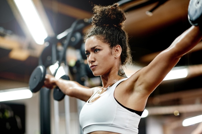 Woman lifting dumbbells in a gym