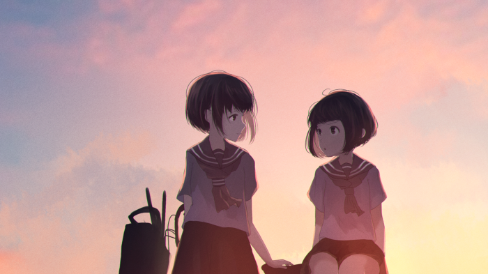 Two schoolgirls in sailor uniforms at sunset