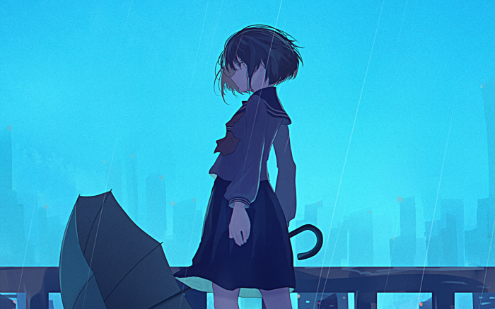 Girl in school uniform with umbrella in the rain
