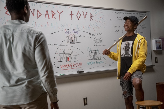 Two men in front of a whiteboard with a diagram