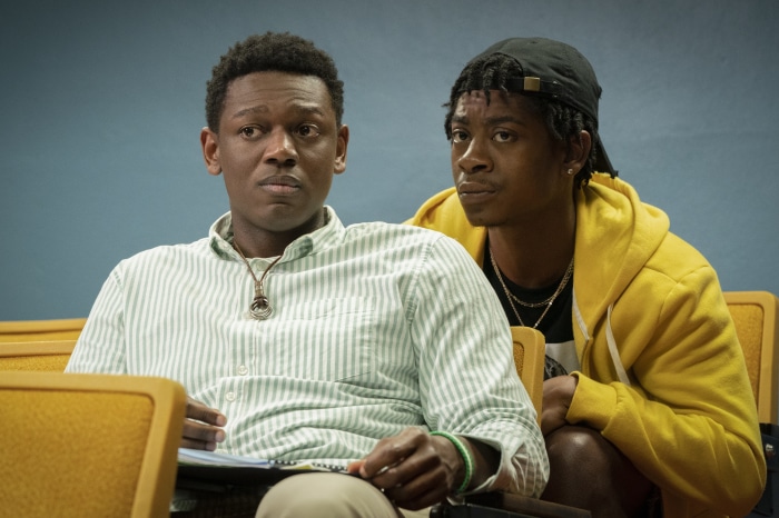 Two young men sitting in chairs