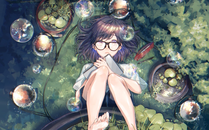 Girl with glasses lying down with sketchbook
