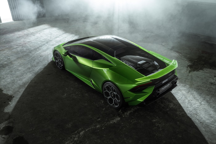 Green Lamborghini Huracán Tecnica in a smoky garage
