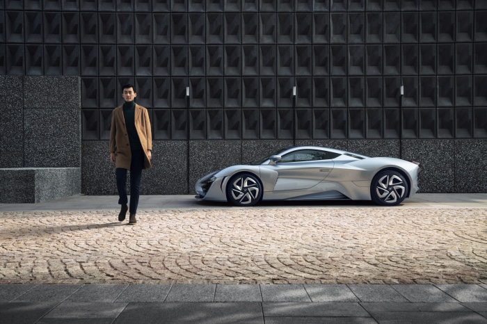 Man walking next to Arcfox-GT car