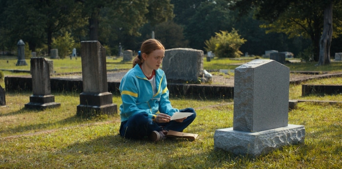 Max from Stranger Things in a graveyard
