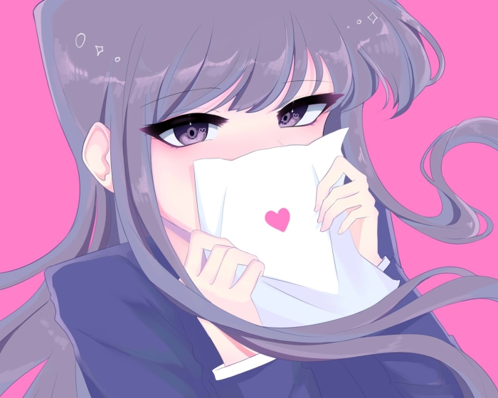 Shoko Komi holding a letter with a heart