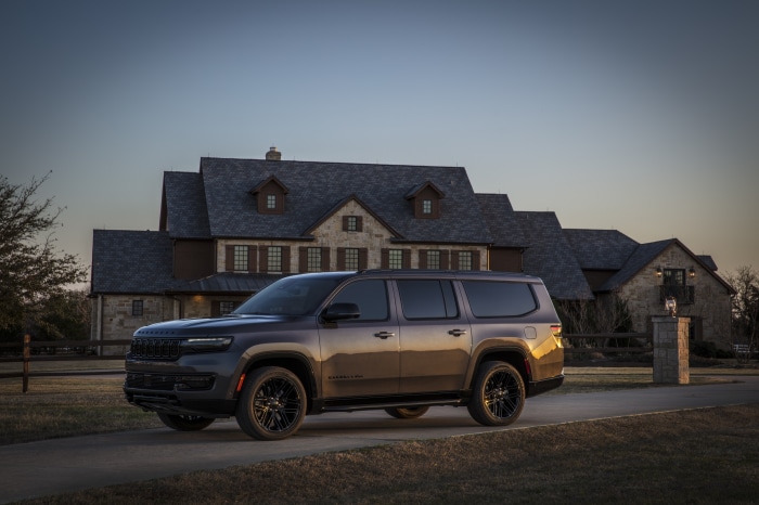 Jeep Wagoneer L parked in front of a large house