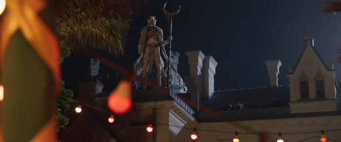 Moon Knight standing on a building at night