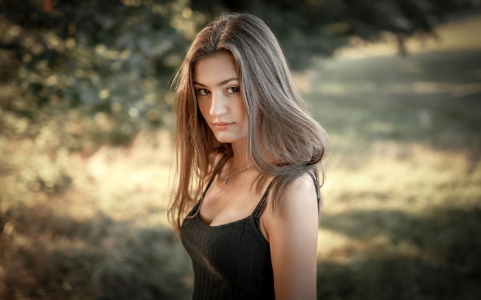 Young woman with long brown hair outdoors