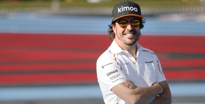 Fernando Alonso wearing Kimoa cap and McLaren shirt