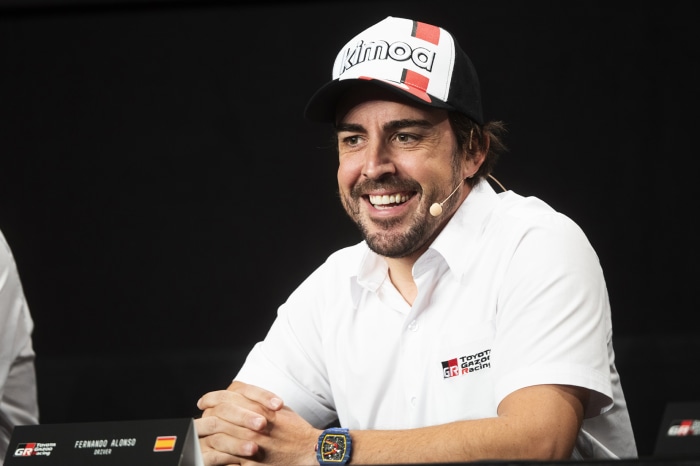 Fernando Alonso wearing a Toyota Gazoo Racing shirt and Kimoa cap