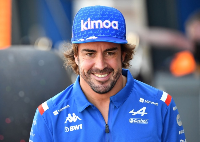 Fernando Alonso wearing a Kimoa cap and Alpine racing shirt