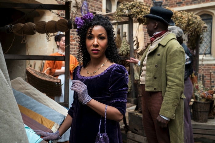 Woman in purple dress and man in green coat in Bridgerton
