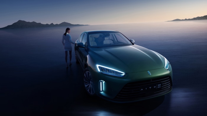 AITO M5 car with woman in desert landscape 4K