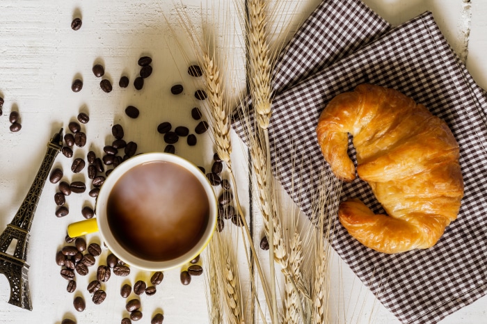 Croissant and coffee with Eiffel Tower miniature