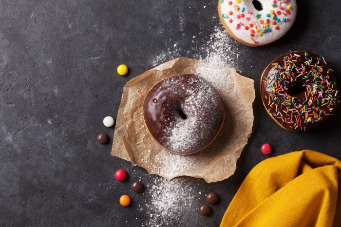 Donuts with chocolate and white icing, sprinkles, and candies