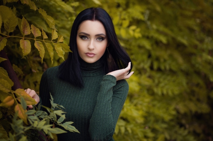 Woman in green turtleneck outdoors